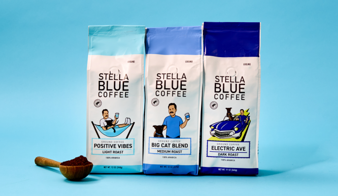 Three bags of stella blue ground coffee with a measuring spoon